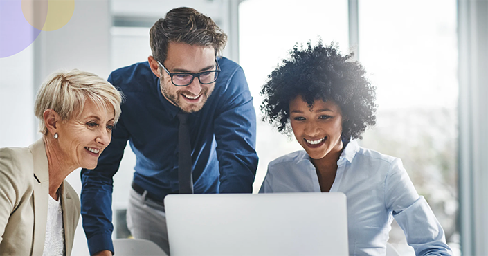 business professionals smiling at computer