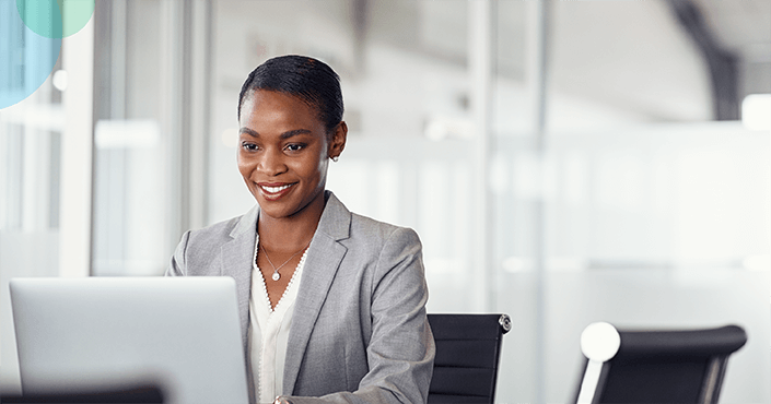 Professional woman smiling at computer (1) (1)