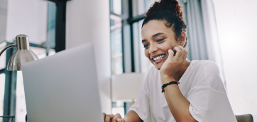 Smiling female looking at a computer - HealthStream