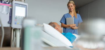 Nurse with a patient in hospital room - HealthStream