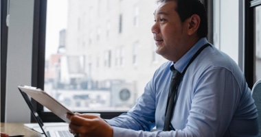 Professional man holding clipboard - Revenue Cycle Education HealthStream