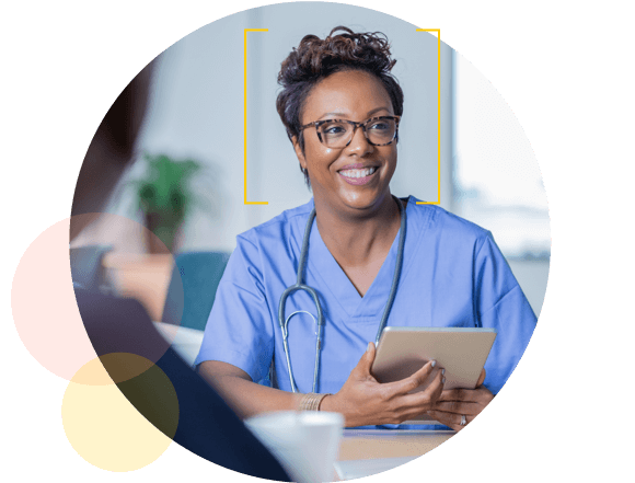 Healthcare worker smiling holding electronic tablet - Healthstream