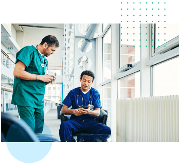 Two medical professionals looking at a mobile phone - Nurse Preceptor Program