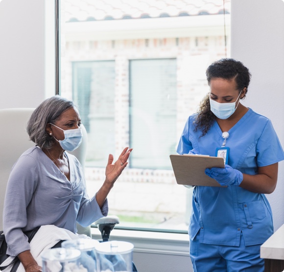 Nurse with patient in hospital room - Quality and Safety HealthStream