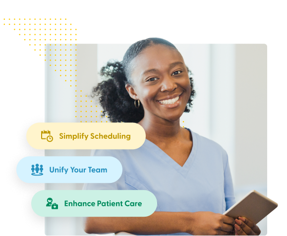 Young black nurse smiling at camera holding tablet