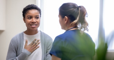 Two females talking - HealthStream&#39;s Regulatory &amp; Compliance Solution
